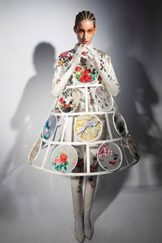 a woman in a dress made out of plates