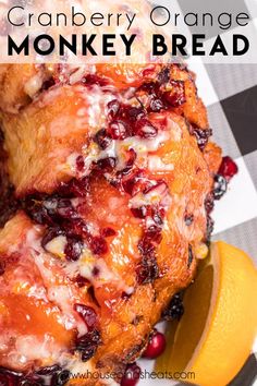 a close up of a chicken on a plate with cranberries and oranges