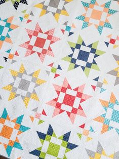 a colorful quilt with many different designs on it