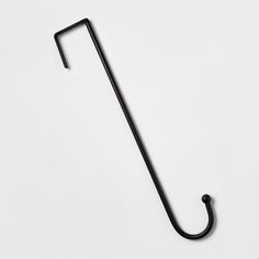 a black metal hook on a white wall with the handle extended to it's side