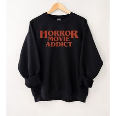 "Get the popcorn ready for a horror movie night in this comfy sweatshirt featuring a \"Horror Movie Addict\" graphic. Ideal for any situation, a unisex heavy blend crewneck sweatshirt is pure comfort. These garments are made from polyester and cotton. This combination helps designs come out looking fresh and beautiful. The collar is ribbed knit, so it retains its shape even after washing. There are no itchy side seams on these sweaters.  50% cotton, 50% polyester Medium-heavy fabric (8.0 oz/yd² Spooky Season Fashion, Horror T Shirt, Horror Cricut Ideas, Horror Movie Merch, Spooky Clothes, Horror Stuff, Horror Outfits Aesthetic, Horror Outfits, Halloween Themed Outfits