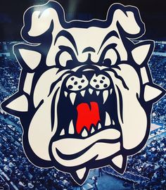 an angry bulldog sticker on the side of a wall in front of a crowd