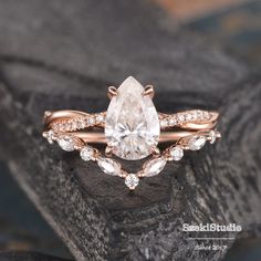 an engagement ring with a pear shaped diamond