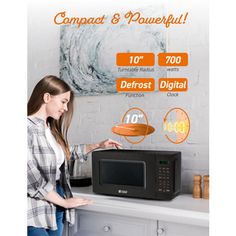 a woman standing in front of a microwave with the words compact & powerful on it