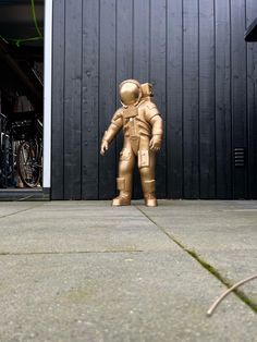 an inflatable astronaut standing next to a garage door