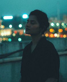 a woman standing in front of a cityscape with the words just breathe above her head