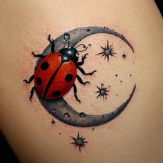 a ladybug sitting on the moon with stars in it's back tattoo