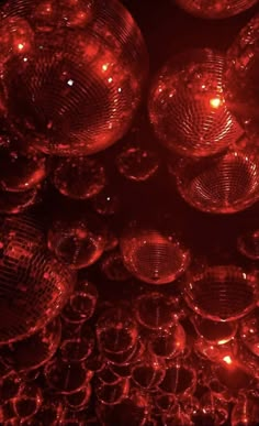 red disco balls in the dark with lights on them