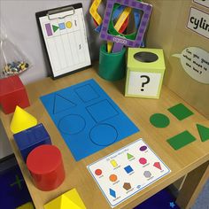 a wooden table topped with lots of different types of shapes and sizes on it's surface