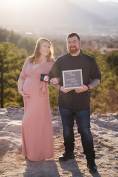 a man and woman standing next to each other holding an award plaque in their hands