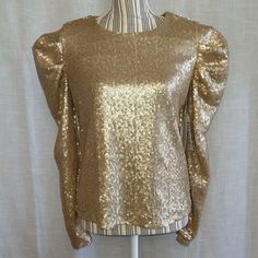 Gold Sequin Long Sleeve Top Blouse Brand: Calligraphie Size: Small Color: Gold Sequin Fabric Long Sleeve Puffed Balloon Sleeve All Lined Round/Crew Neck Keyhole With Button Closure Pullover New With Tags Please See All Pictures For Details Padded Blouse Tops For Celebration, Gold Long Sleeve Tops For Spring, Fall Party Blouse With Crew Neck, Gold Long Sleeve Party Top, Gold Long Sleeve Top For Party, Gold Long Sleeve Tops For Night Out, Gold Fitted Tops For Party Season, Gold Fitted Blouse For Fall, Fitted Gold Padded Blouse