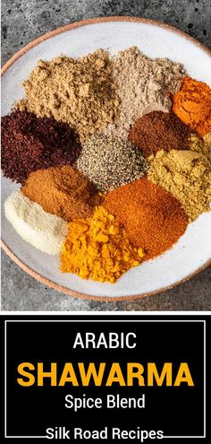 a white plate topped with different types of spices next to a black and white sign