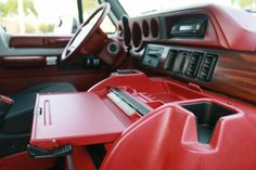 the interior of a vehicle with red leather seats