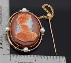 "This is a 18K Superb Bissinger Signed Yellow Gold Cameo Pendant Brooch - Carnelian Cameo Natural Pearl and native cut Cameo Pin tilted on back. \"Isabella 1760\" carved into the back and \"Brown + Rogers\" carved also, 8 old mine diamonds, 4 pearls to open frame, dated 1876 with safety stick pin, measures 32 x 40 mm, weight 30.6 grams, signed on front left. Bissinger is seldom offered for sale. Stock # BB76CRL25" Yellow Gold Baroque Brooch For Formal Occasions, Formal Yellow Gold Baroque Brooches, Luxury Intaglio Brooch For Formal Occasions, Victorian Brooches For Ceremonial Occasions, Victorian Engraved Brooches For Formal Occasions, Victorian Engraved Brooches For Formal Wear, Heirloom Cameo Brooch For Formal Occasions, Heirloom Style Cameo Brooch For Formal Occasions, Heirloom Cameo Brooches For Formal Occasions