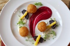 a white plate topped with food on top of a wooden table