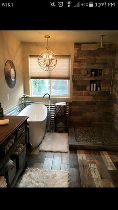 a bathroom with a bathtub, rugs and wooden walls on the wall next to it