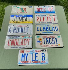 several license plates are laid out on a table in front of some grass and flowers