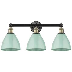 three light bathroom fixture in an antique brass finish with green glass shades and black metal fittings