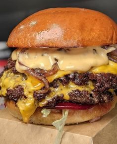 a cheeseburger sitting on top of a cardboard box