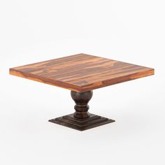 a square wooden table sitting on top of a metal base