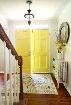 a yellow door is in the entry way