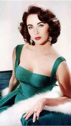 an old photo of a woman in a green dress