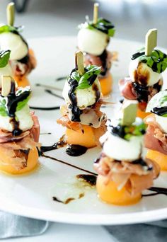 small appetizers are arranged on a white plate