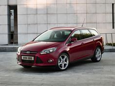 a red ford focus parked in front of a building