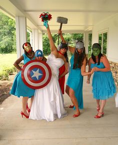 four women dressed up as superheros and gladiators pose for a photo on the porch