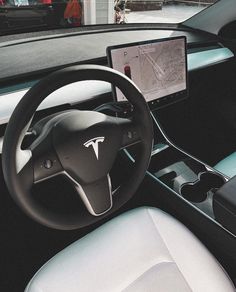 the interior of a car with a steering wheel, dashboard and touch screen display on it