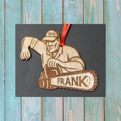 a wooden ornament depicting a man on a skateboard with the name frank