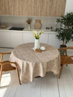 a table with two chairs and a vase on it