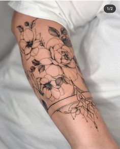 a woman's arm with flowers on it