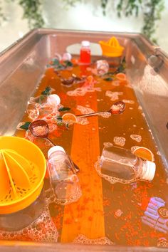 an old fashioned game is being played with plastic cups and spoons on the table