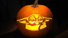 a carved pumpkin with an image of yoda on it