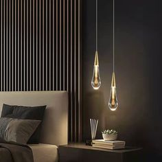 three lights hanging from the ceiling above a bed in a room with black walls and wooden slats