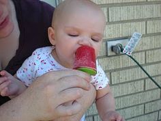 a man holding a baby and eating something