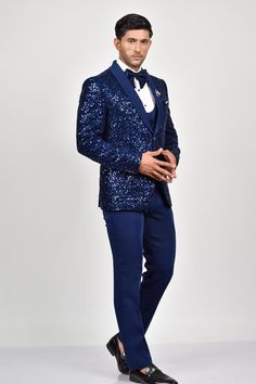 Blue tuxedo with bead embroidery details. Paired with a waistcoat with a sequin embroidered flap, shirt, pant and bow.
Components: 5
Pattern: Embroidered
Type Of Work: Sequin
Neckline: Lapel collar
Sleeve Type: Long
Fabric: Crepe, Handloom Silk, Terry Rayon
Color: Blue
Other Details: 
Note: Brooch and pocket square shown in the image is not for sale.
Occasion: Cocktail and Reception - Aza Fashions Embellished Fitted Sets For Gala, Party Suits With Embellished Notch Lapel, Elegant Blue Sets With Sequins, Elegant Blue Sequined Sets, Royal Blue Tuxedo Suit For Party, Fitted Three-piece Suit With Suit Collar For Party, Embellished Fitted Suits For Gala, Fitted Embellished Suits For Gala, Fitted Sequined Suits For Parties