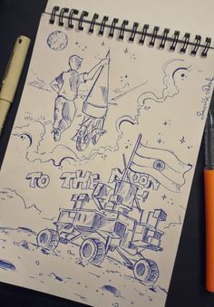 a notebook with a drawing of an astronaut on it next to a pen and orange marker