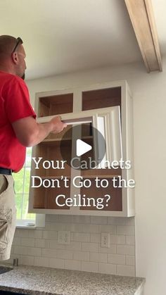 a man standing in front of an open cabinet with the words, your cabinets don't go to the ceiling?