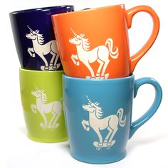 four colorful cups with unicorns on them sitting side by side in front of each other