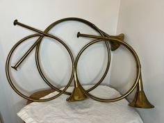 three brass bells on top of a white towel