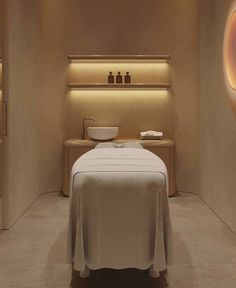 a spa room with a bed, sink and lights