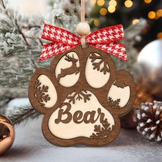 a wooden ornament with a dog's paw and the word bear on it