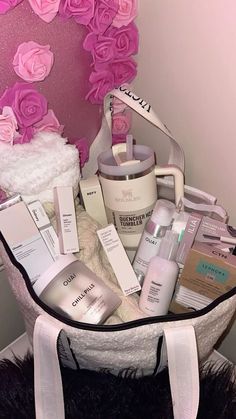 a white basket filled with lots of beauty products next to a pink heart shaped wall