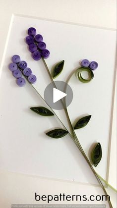 the video shows how to make flowers out of buttons and paper with scissors on them