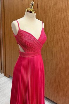 a mannequin wearing a pink pleated dress