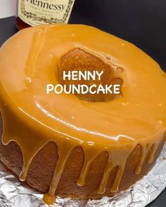 there is a cake with icing on it and the words henny poundcake