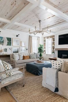 a living room filled with furniture and a flat screen tv mounted to the wall over a fireplace