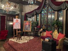 a living room filled with furniture and paintings